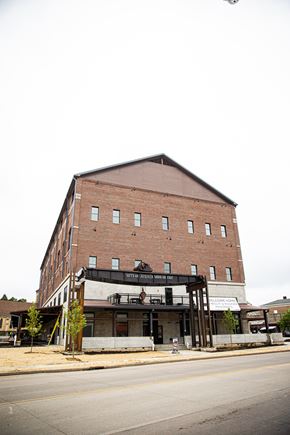 Beloit apartment for rent - A large red brick building with a black awning on the front.