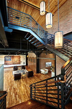 Indianapolis apartment for rent - A wooden staircase with a metal railing leads to the upper floor of a house.