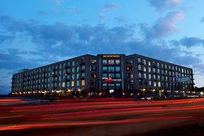 Indianapolis apartment for rent - a large hotel building at night with streaks of traffic