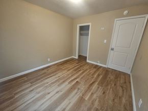 Pittsburg apartment for rent - A room with wooden flooring and a white door.
