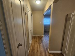 Pittsburg apartment for rent - A hallway with a light on the ceiling and a door on the left.