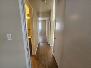 Antioch apartment for rent - A long hallway with doors on both sides and a light switch on the wall.