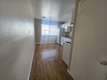 Antioch apartment for rent - A kitchen area with white cabinets and a wooden floor.