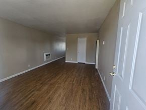 Antioch apartment for rent - A room with wood flooring and white walls.