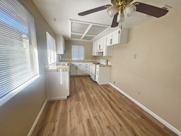 Pittsburg apartment for rent - A kitchen with a ceiling fan and wooden floors.