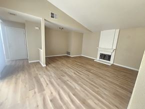 Pittsburg apartment for rent - A room with wooden flooring and a fireplace.