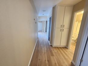 Pittsburg apartment for rent - A hallway with wooden floors and white walls.