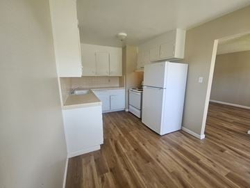 Antioch apartment for rent - A kitchen with white appliances and wooden floors.