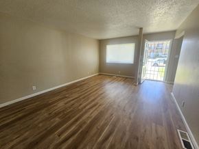 Antioch apartment for rent - A room with wooden flooring and a door leading to a balcony.