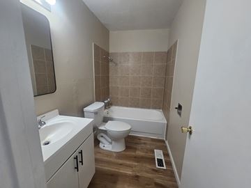 Antioch apartment for rent - A bathroom with a white sink, toilet, and bathtub.