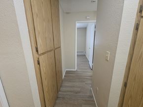 Bay Point apartment for rent - A hallway with wooden doors and a grey carpet.
