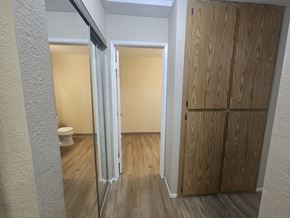 Bay Point apartment for rent - A bathroom with a toilet, a shower with a glass door, and a wooden wardrobe.