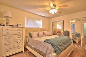 Pearland apartment for rent - a bedroom with a bed and a ceiling fan