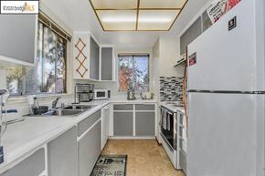 Bay Point condo for rent - a white kitchen with a sink and a refrigerator