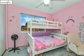 Bay Point condo for rent - a bedroom with pink walls and a bunk bed