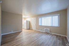 Antioch apartment for rent - A room with wooden floors and a window with blinds.