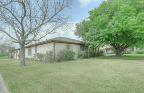 Pearland apartment for rent - a white house with a yard and trees