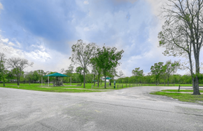 Pearland apartment for rent - a road leading to a park with trees and a gazebo