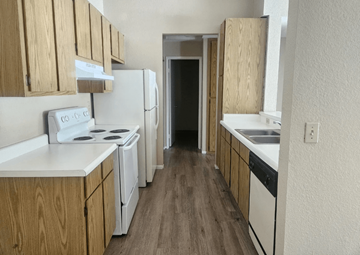 Bay Point apartment for rent - A kitchen with white appliances and wooden cabinets.