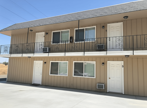 Antioch apartment for rent - A beige building with a black railing and white doors.
