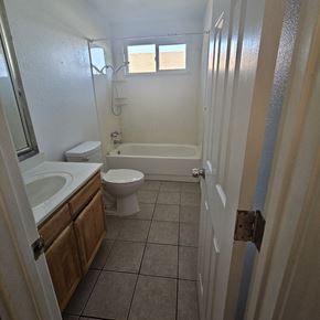 Antioch apartment for rent - A bathroom with a toilet, sink, and bathtub.