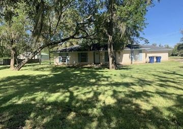 Lake Jackson apartment for rent - a house with a yard and trees in front of it