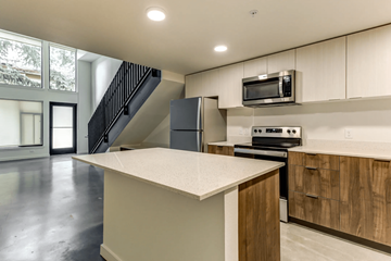 Seattle apartment for rent - A kitchen with a white counter top and wooden cabinets.