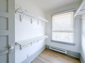 Seattle triplex for rent - A white closet with a window and a door.