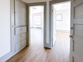 Seattle triplex for rent - A white room with a wooden floor and a white door.