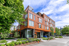Seattle apartment for rent - A modern building with a brown facade and glass windows.