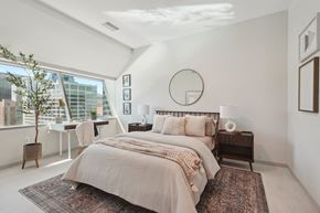 Cleveland apartment for rent - A bedroom with a large bed and a view of the city.
