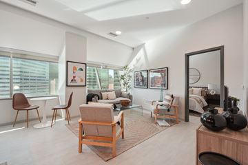 Cleveland apartment for rent - A living room with a brown chair and a white couch.