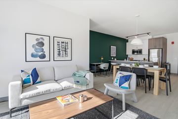 Arlington Heights apartment for rent - A modern living room with a white sofa and a wooden coffee table.