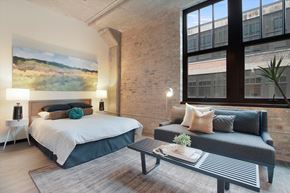 Chicago apartment for rent - a bedroom with a bed and a couch in a loft