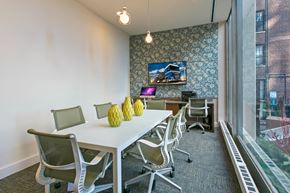 Chicago apartment for rent - a conference room with a table and chairs and a large window