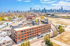 Chicago apartment for rent - an aerial view of a building with a city skyline in the background