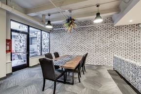 Chicago apartment for rent - a dining room with a table and chairs and a brick wall