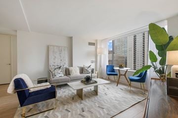 Chicago apartment for rent - A living room with a blue chair and a grey couch.
