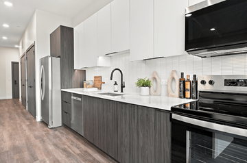 Chicago apartment for rent - A modern kitchen with a stainless steel refrigerator and oven.