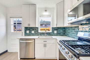 Denver apartment for rent - A kitchen with white cabinets and a stainless steel dishwasher.