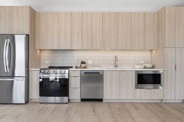 Chicago apartment for rent - A modern kitchen with wooden cabinets and stainless steel appliances.