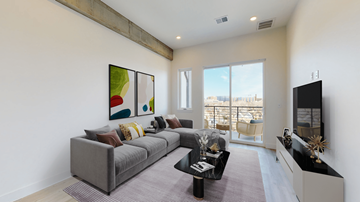 Denver apartment for rent - A living room with a grey couch and a painting on the wall.