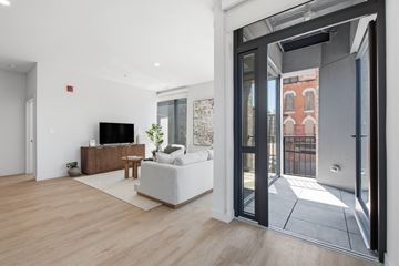 Chicago apartment for rent - A modern living room with a white sofa and a wooden coffee table.