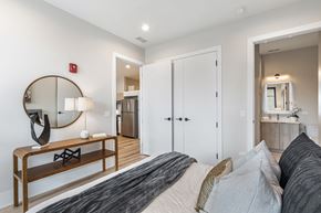 Chicago apartment for rent - A bedroom with a large bed and a mirror on the wall.