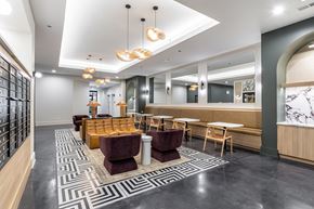 Chicago apartment for rent - A modern lounge area with a patterned carpet and wooden furniture.