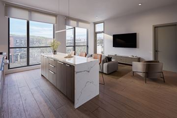 Chicago apartment for rent - A modern kitchen with a marble island and wooden floors.