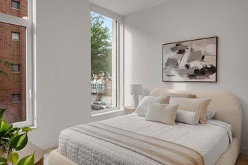 Chicago apartment for rent - A bedroom with a large bed and a painting on the wall.