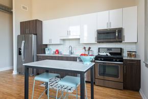 Chicago apartment for rent - A kitchen with a table and chairs in the middle of it.