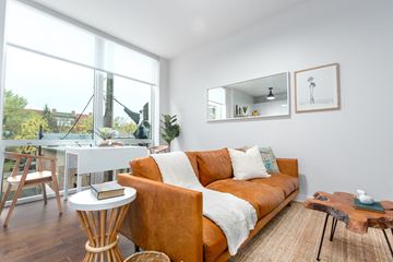 Chicago apartment for rent - A living room with a brown couch and a white table.