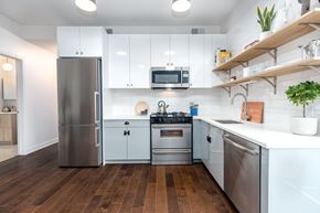 Chicago apartment for rent - A modern kitchen with stainless steel appliances and wooden floors.